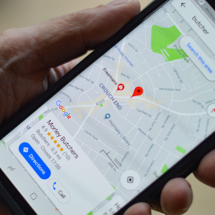 person on phone using Google My Business to promote business locally