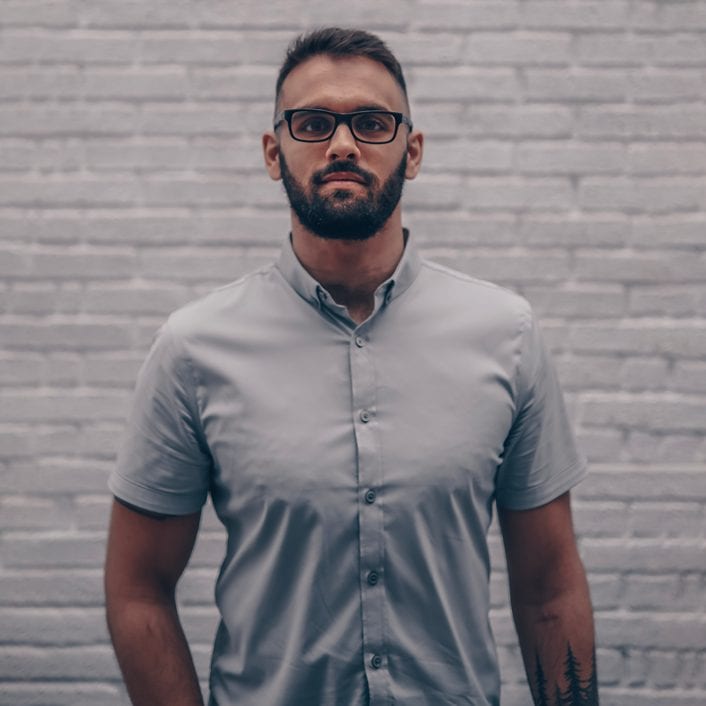 tips on how to take a headshot photos outside with man posing for photo under overcast sky